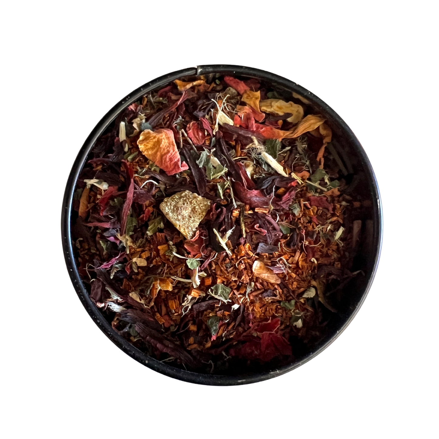 Black bowl filled with colorful dried herbs and spices on a white background