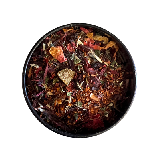 Black bowl filled with colorful dried herbs and spices on a white background